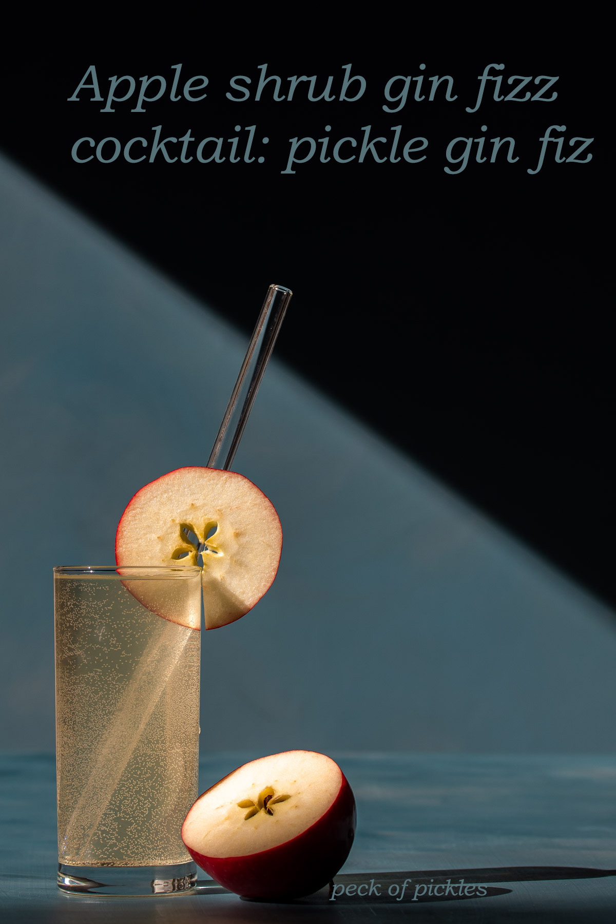 apple shrub gin fizz cocktail or pickle gin fiz on a blue background with hard light and shadows