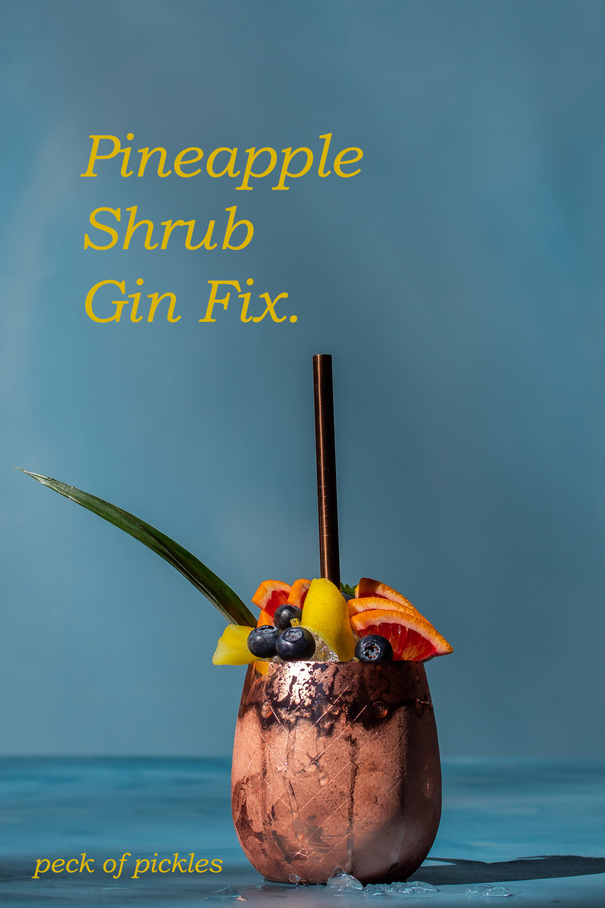 pineapple shrub gin fix cocktail isolated on blue background