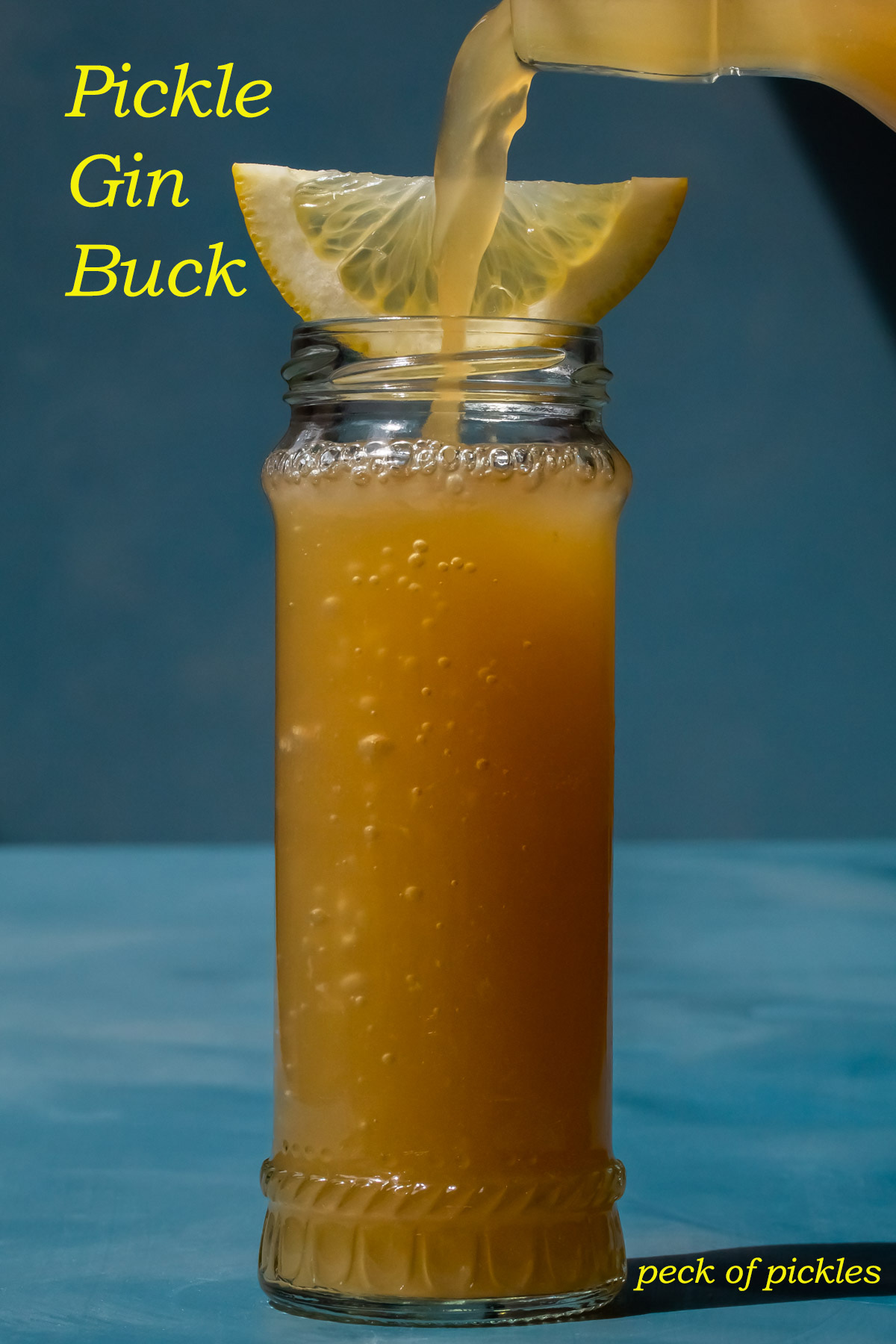 pouring ginger beer for a Pickle Gin Buck Cocktail