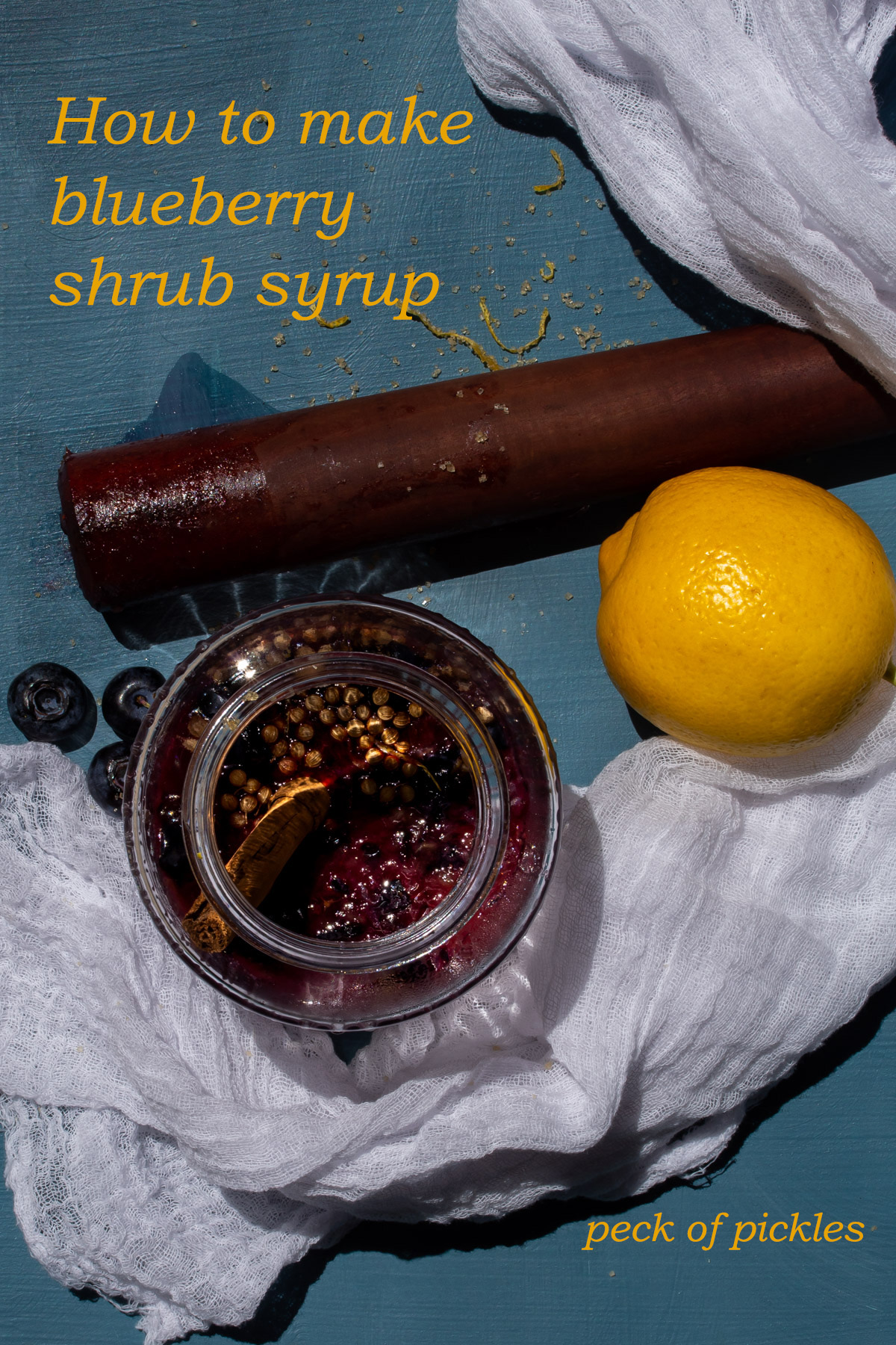 making blueberry shrub syrup from above on blue background