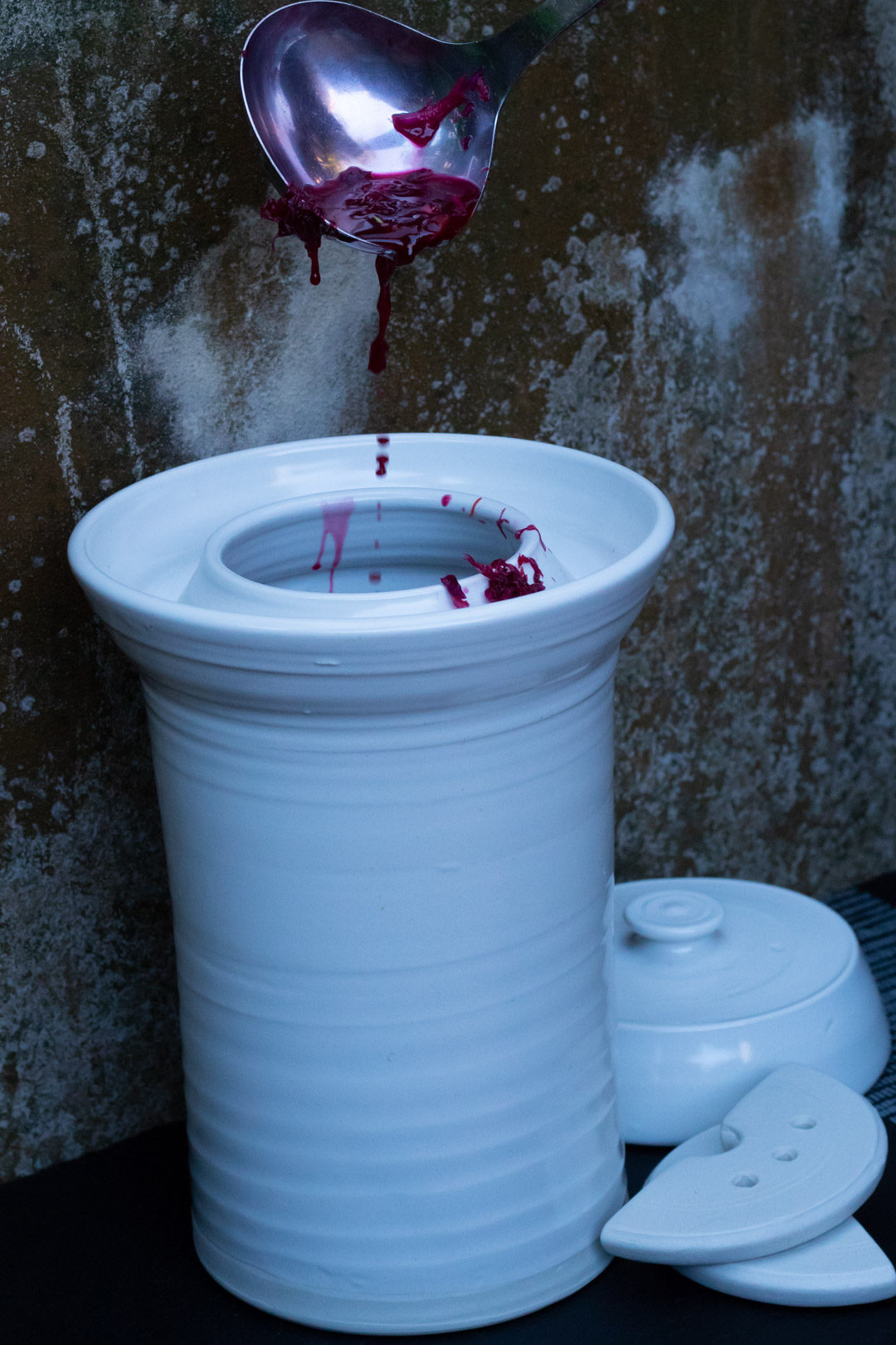 spiced beetroot sauerkraut pouring brine into fermenting pot