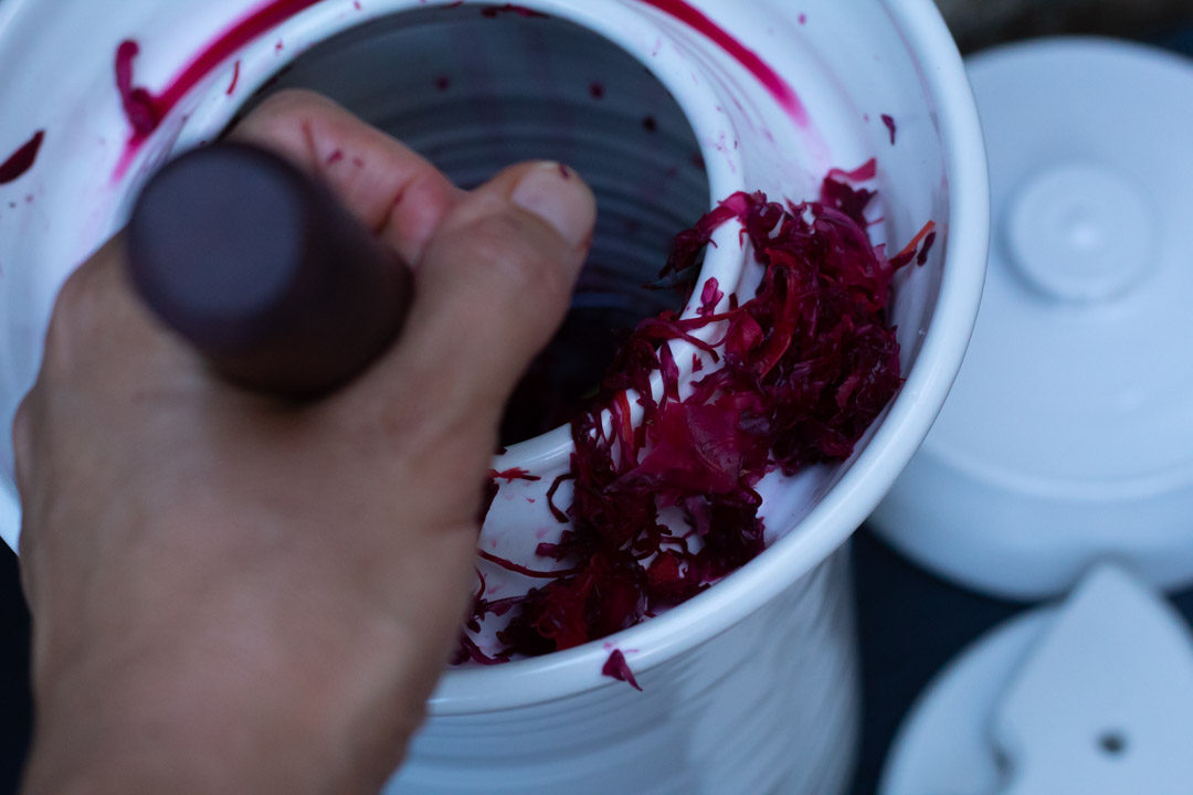 spiced beetroot sauerkraut with fermenting pot and mallet