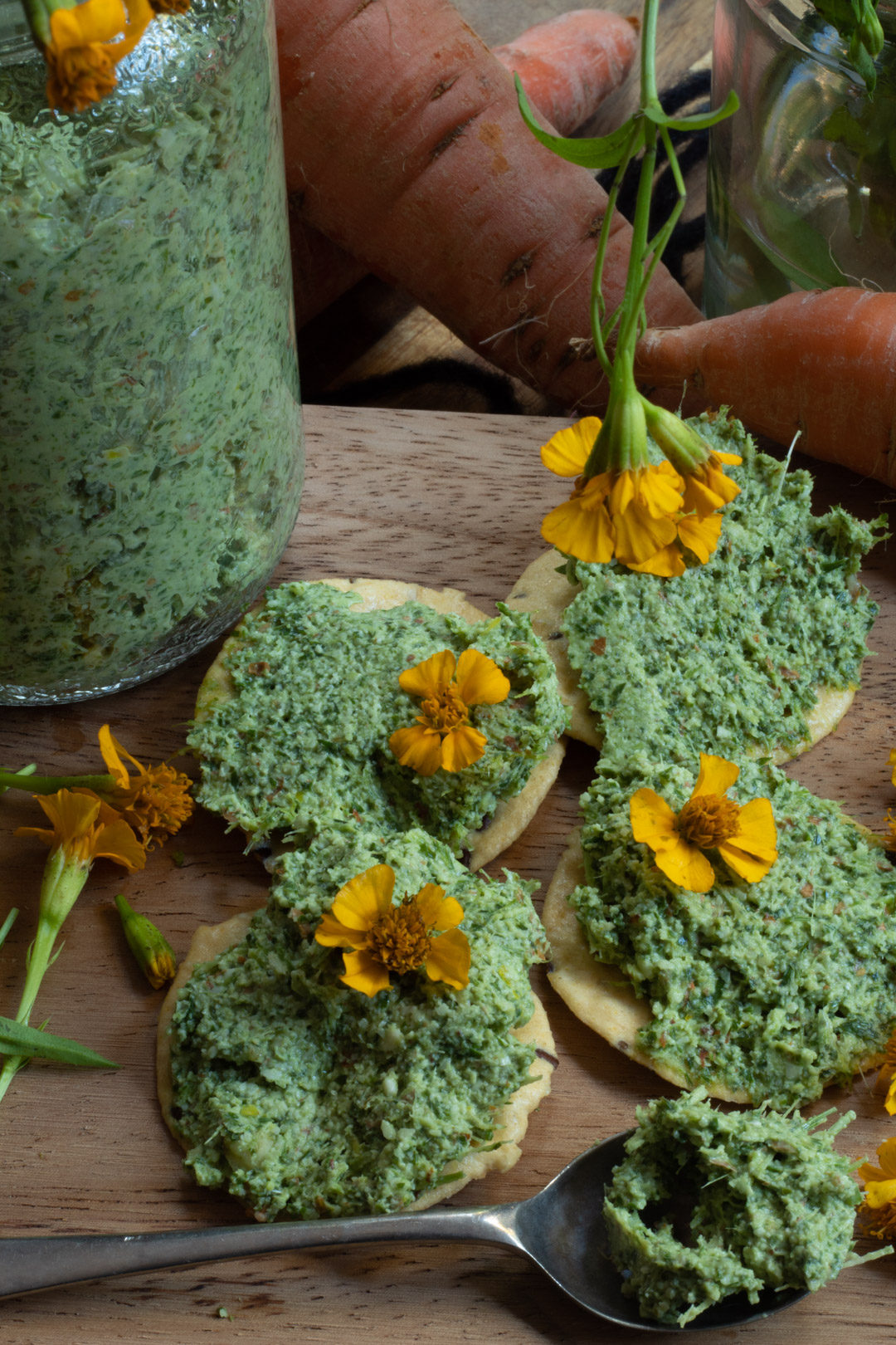 carrot top pesto crackers flat lay