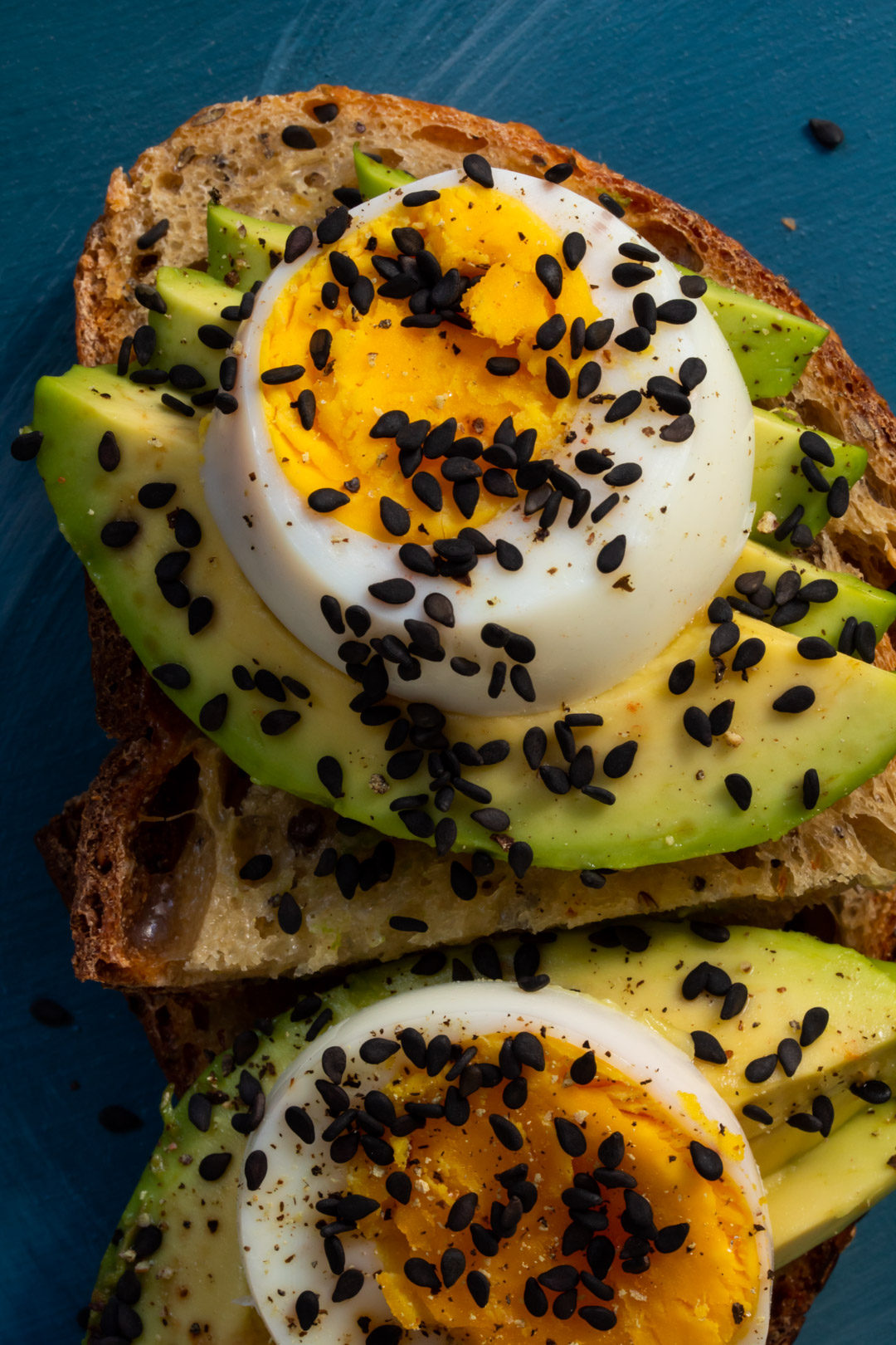 avocado toasts with hard boiled eggs close up