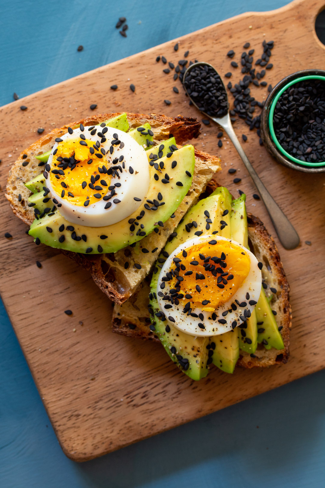 avocado toasts with hard boiled eggs on chopping board