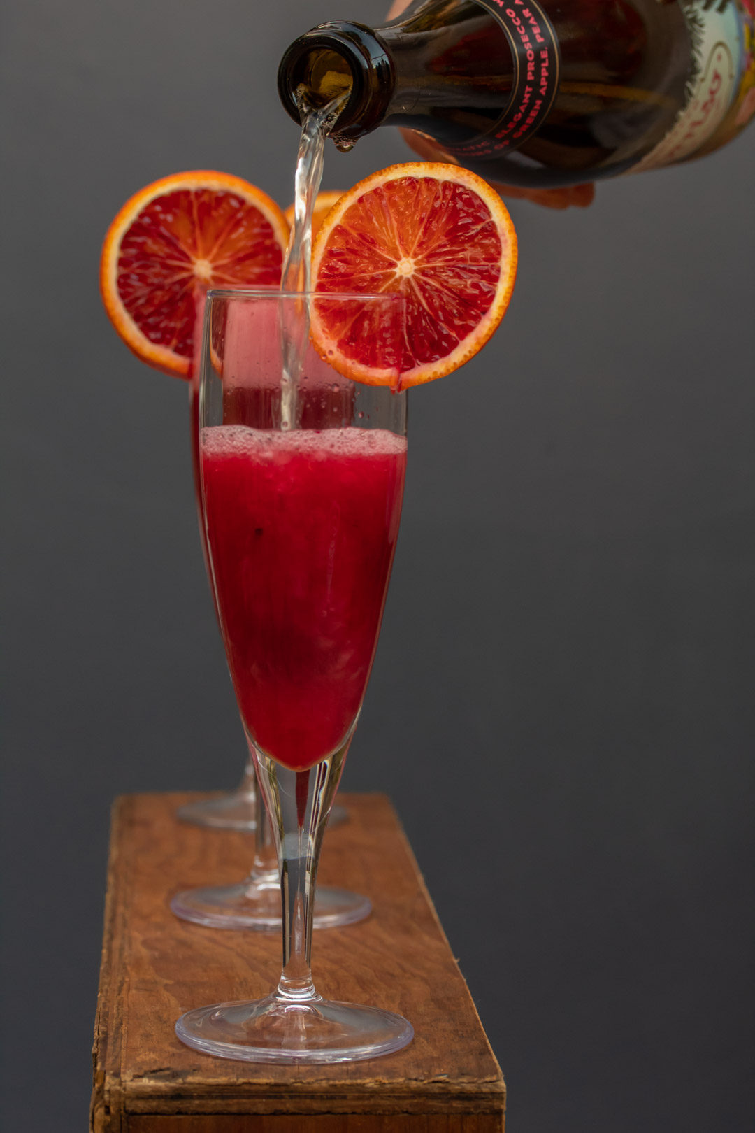 pickled cherry blood orange prosecco pour