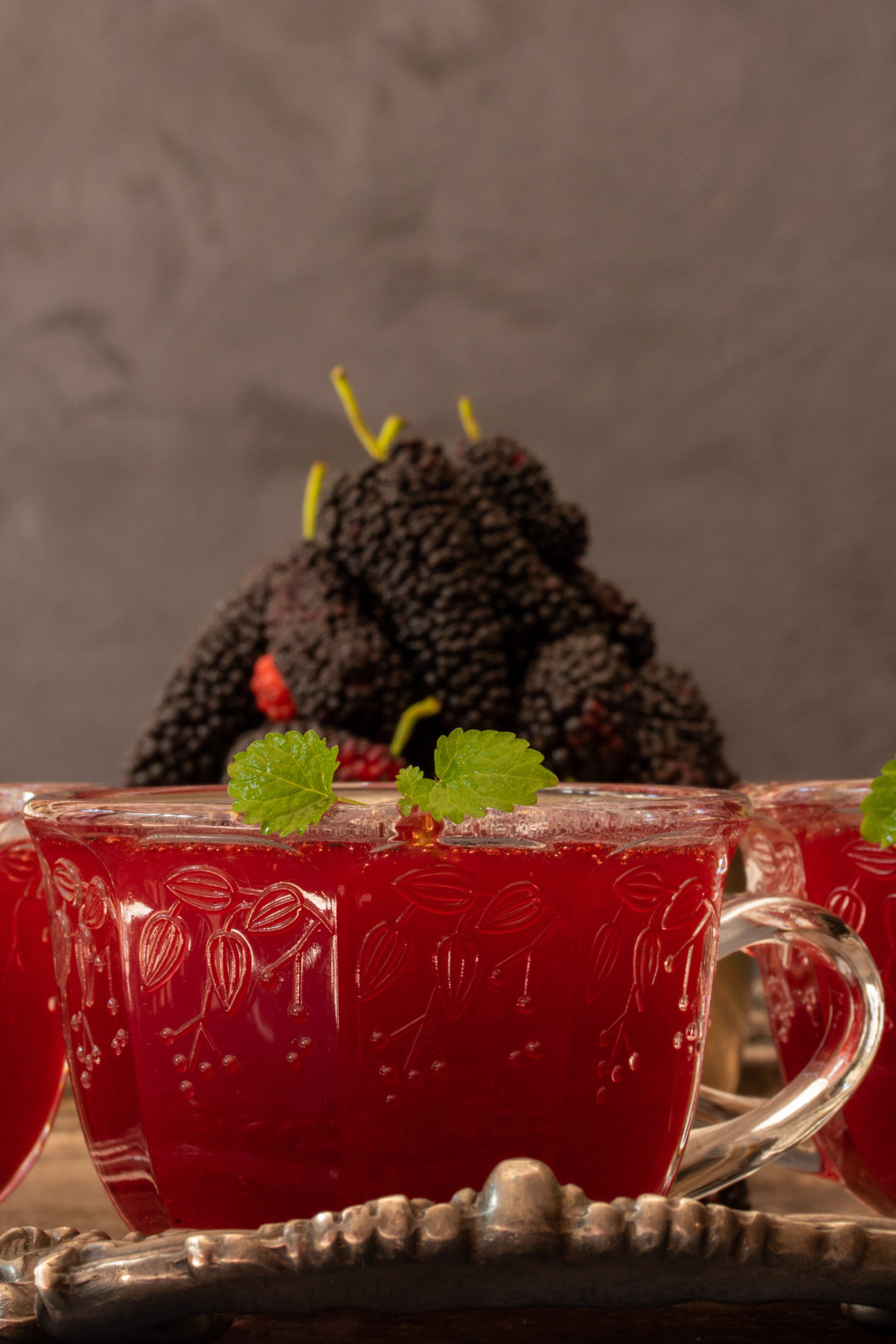 spiced mulberry shrub with mulberries in background
