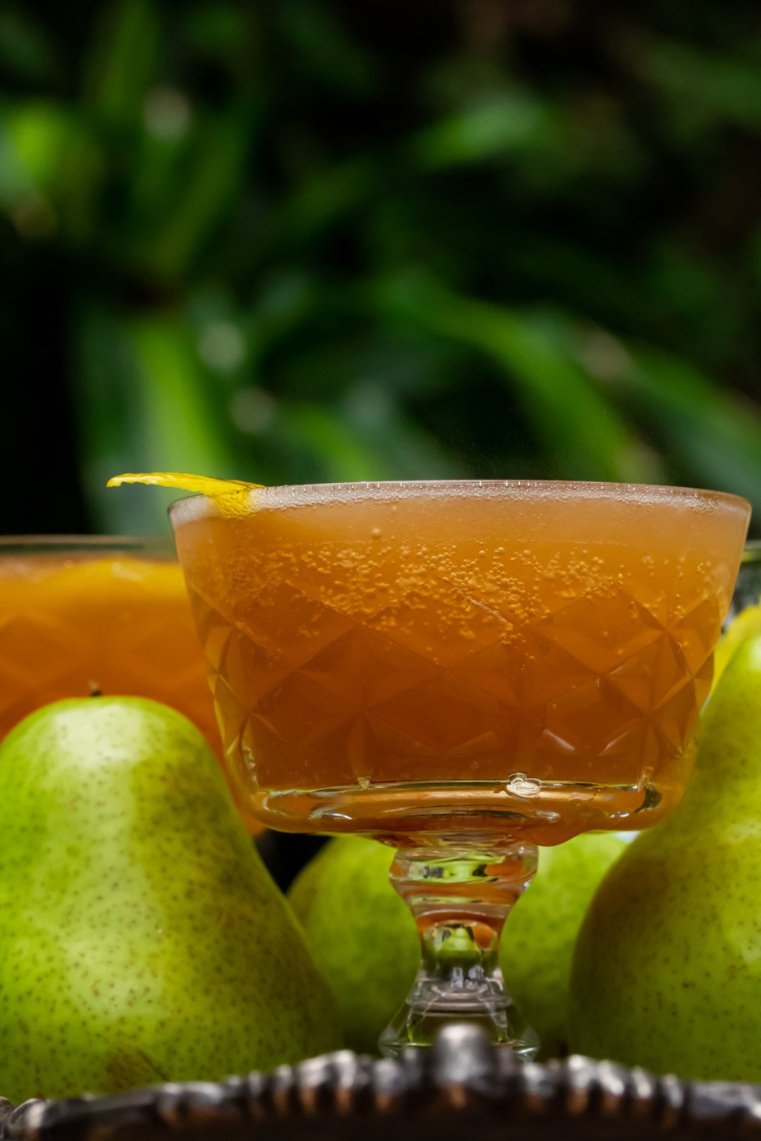 ginger pear champagne cocktail: eye level lemon garnish to left