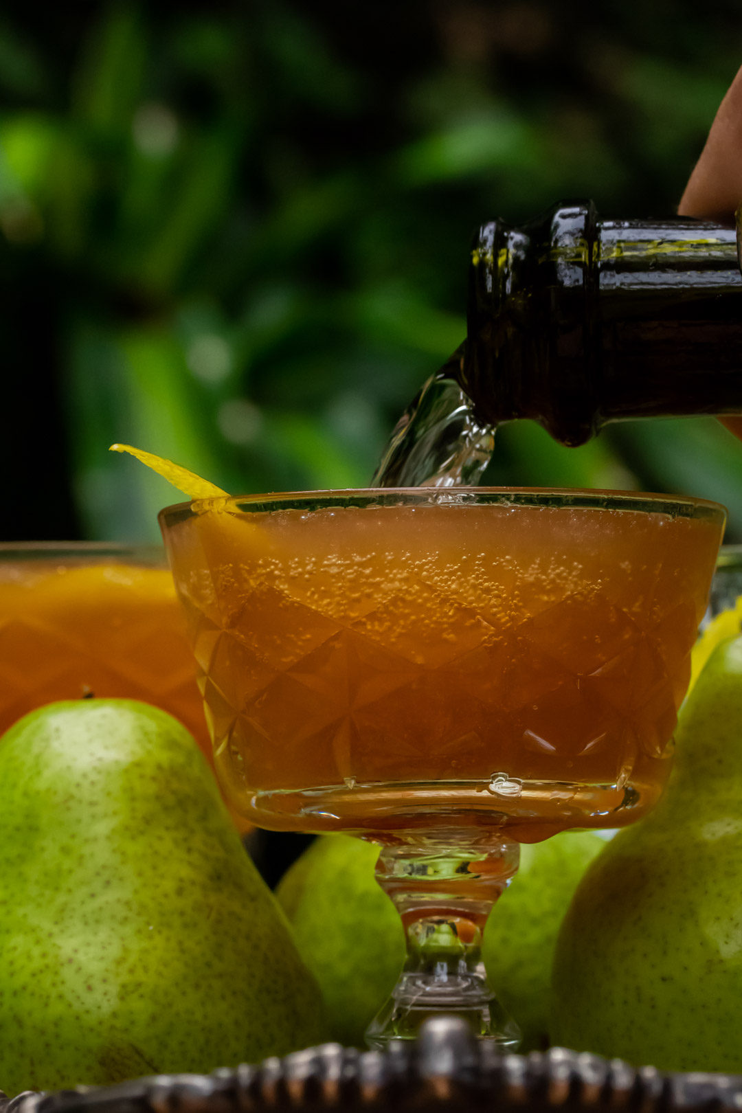 ginger pear champagne cocktail: pouring champagne with bubbles