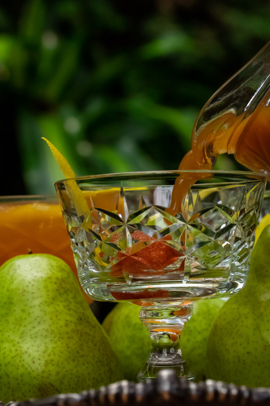 ginger pear champagne cocktail: pouring spiced ginger pear shrub syrup