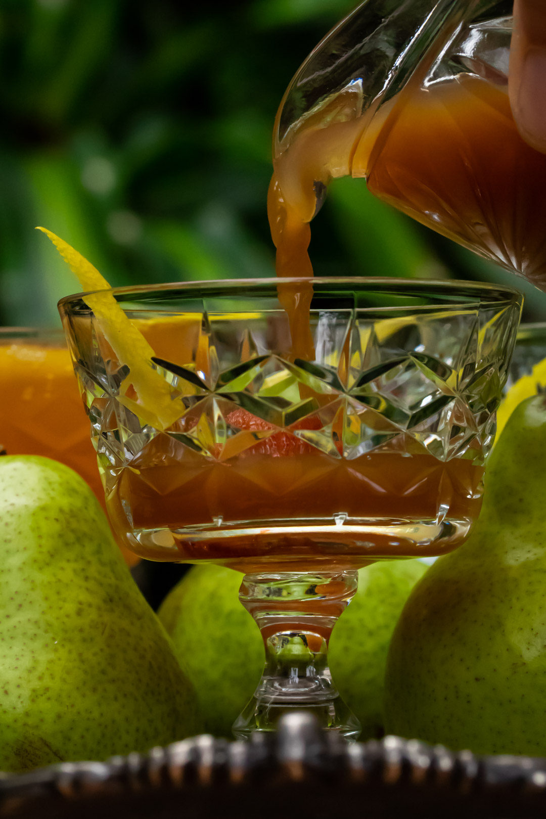 ginger pear champagne cocktail: pouring spiced ginger pear shrub syrup