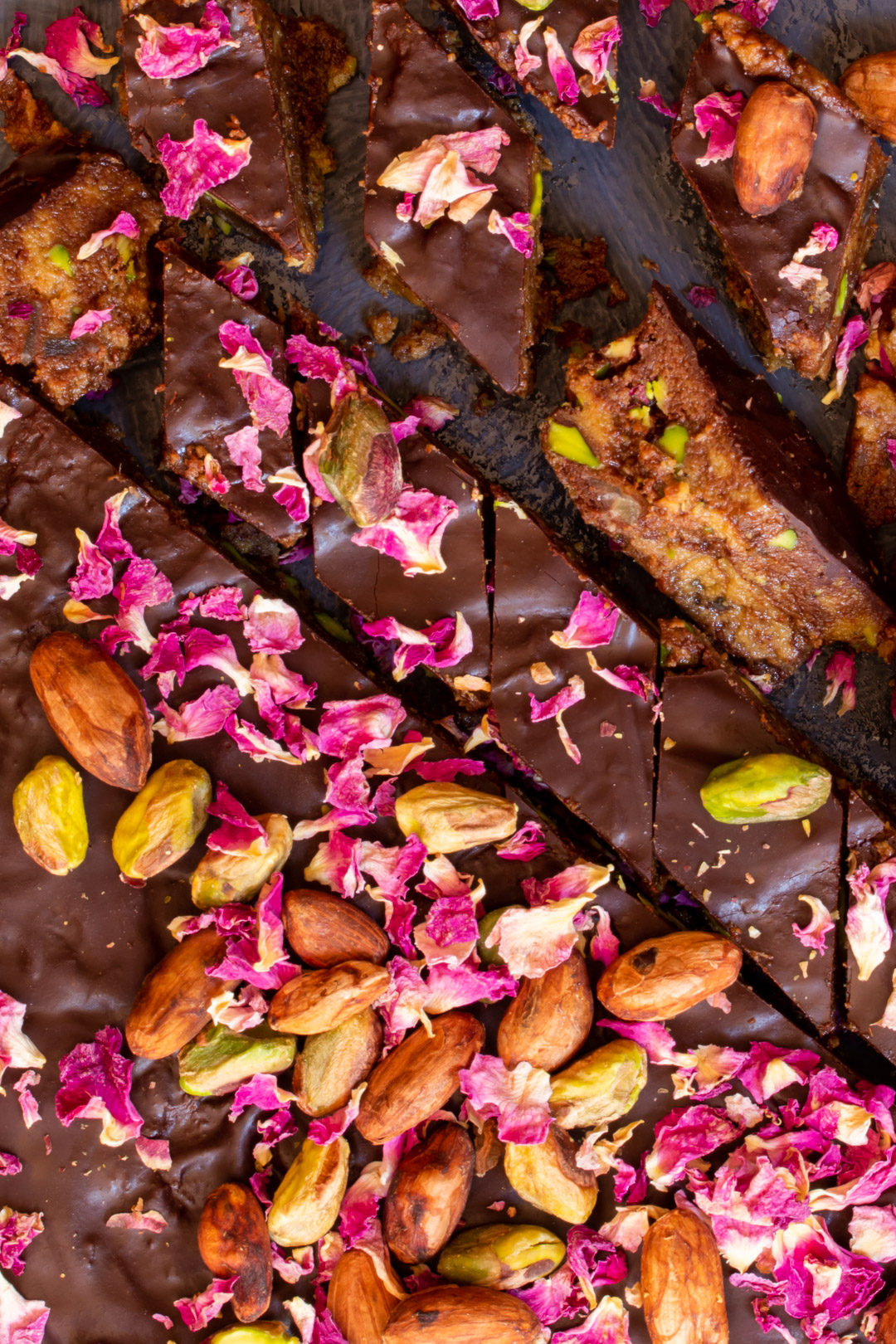 Spiced raw cacao halva with pistachios, ginger, cardamom and rose: cut round from above closer