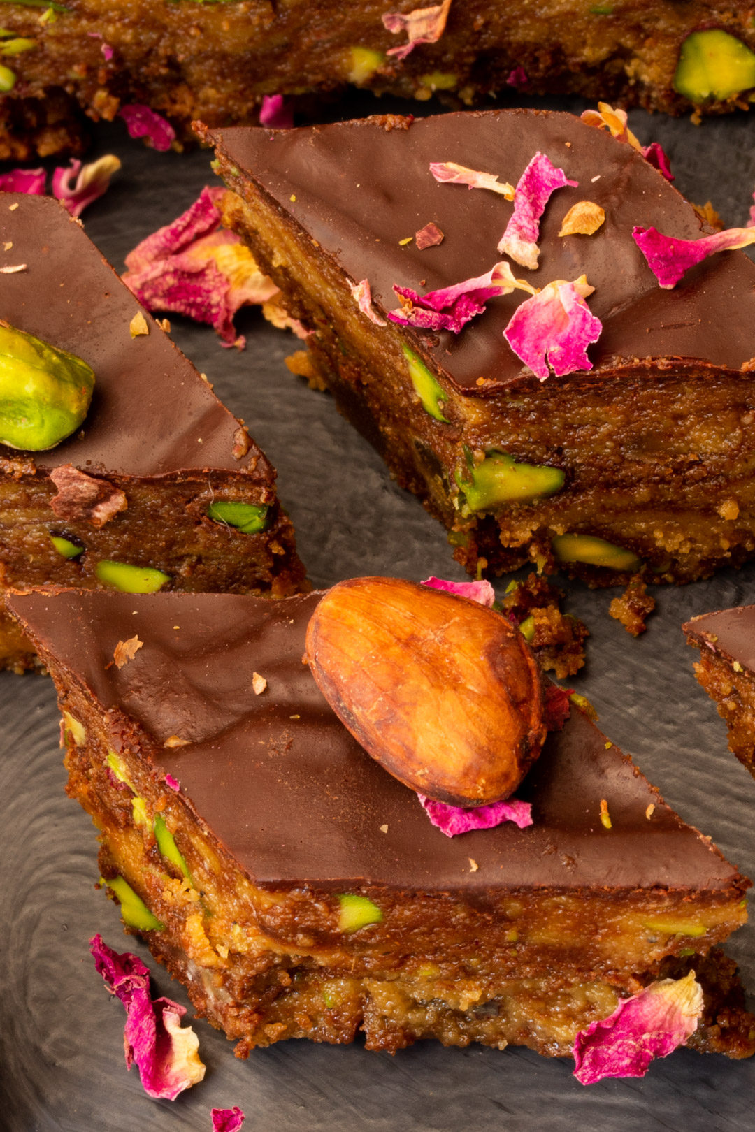 Spiced raw cacao halva with pistachios, ginger, cardamom and rose: diamond pieces close up