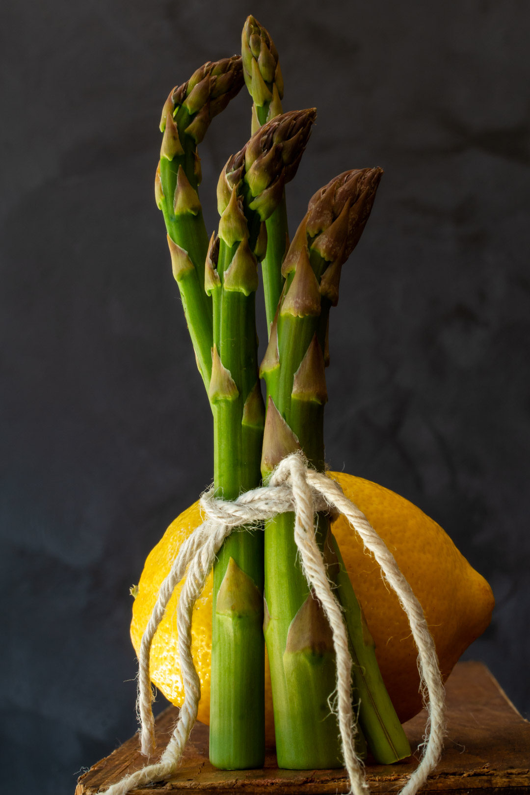 asparagus & lemon tart: asparagus and lemon still life on wooden box