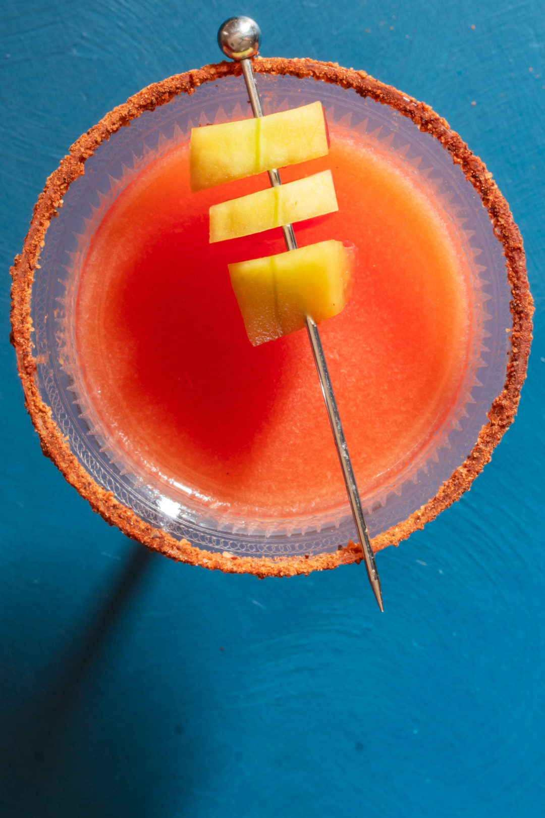 Pickled watermelon rind margarita cocktail with chili-lime-cinnamon salt: from above with small shadow