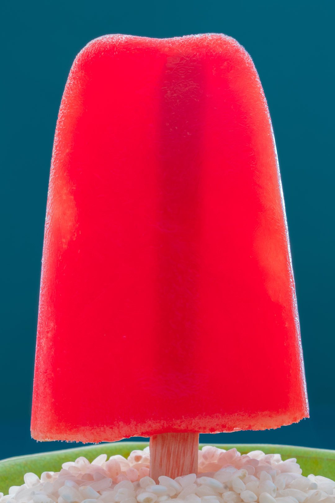 Watermelon paletas with chili-lime salt: single paleta with back light