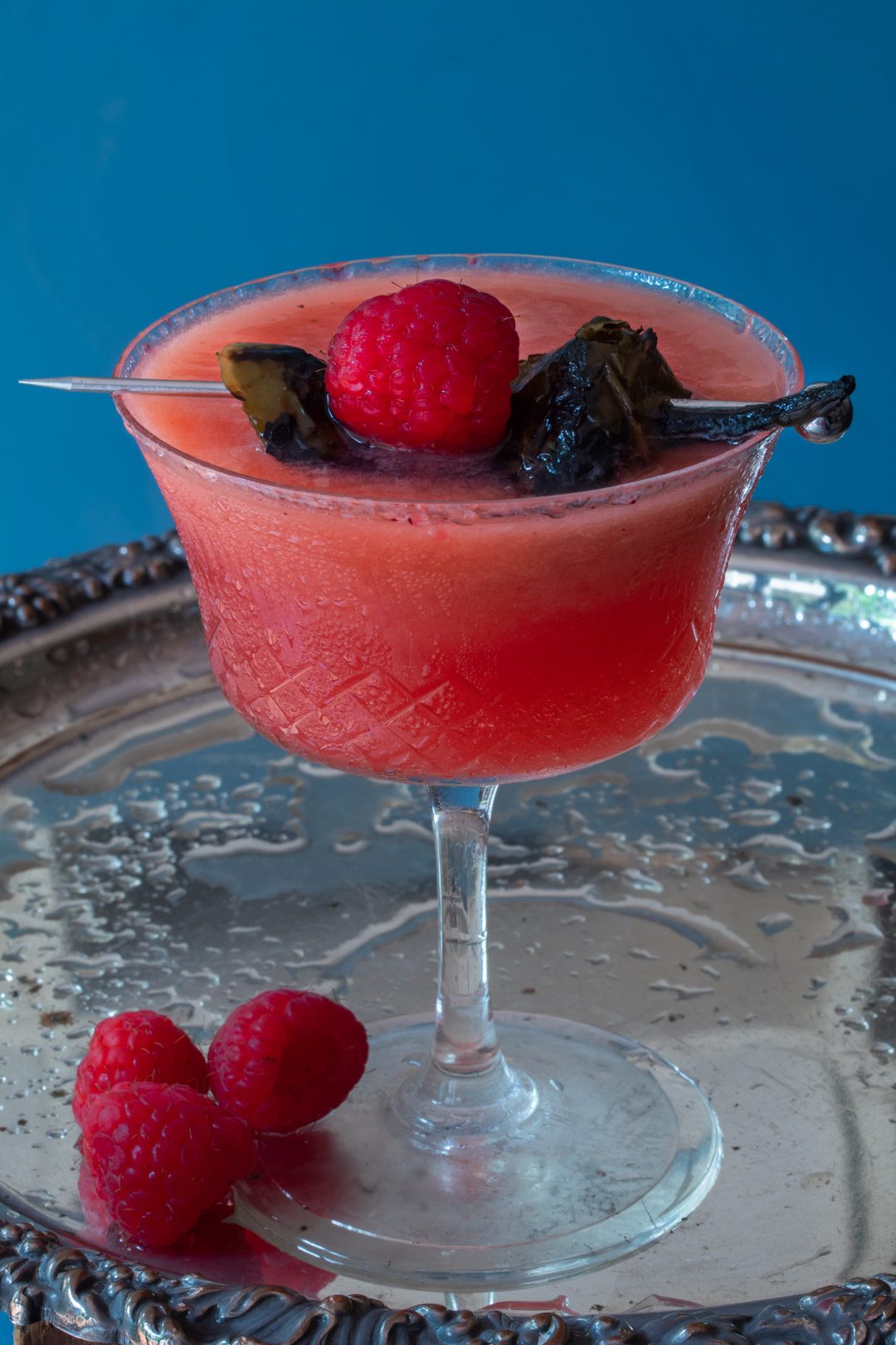 Pickled jalapeno and raspberry margarita cocktail with hibiscus sugar: on silver tray