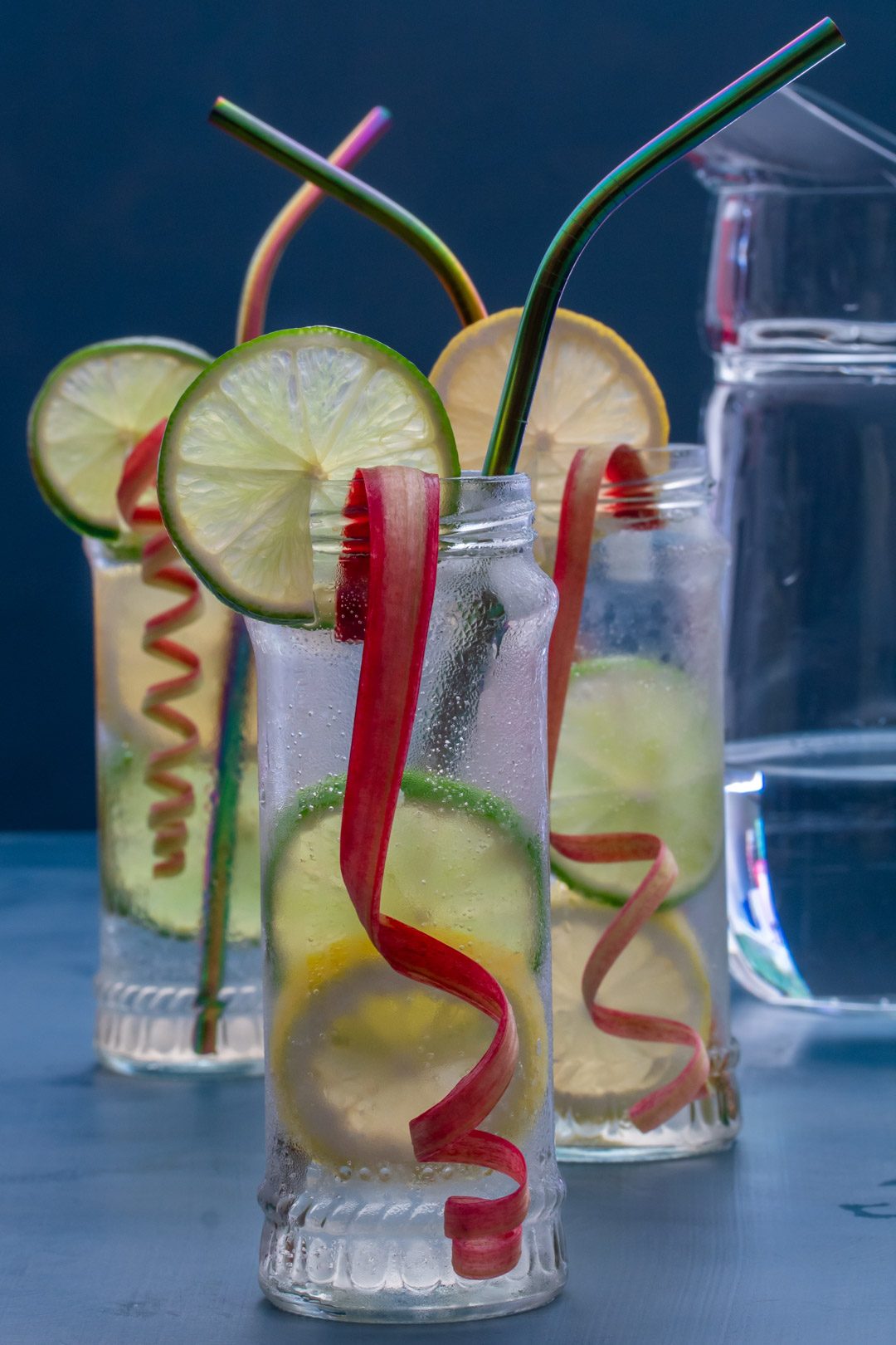 lemon, lime and rhubarb bitters with jug in right background