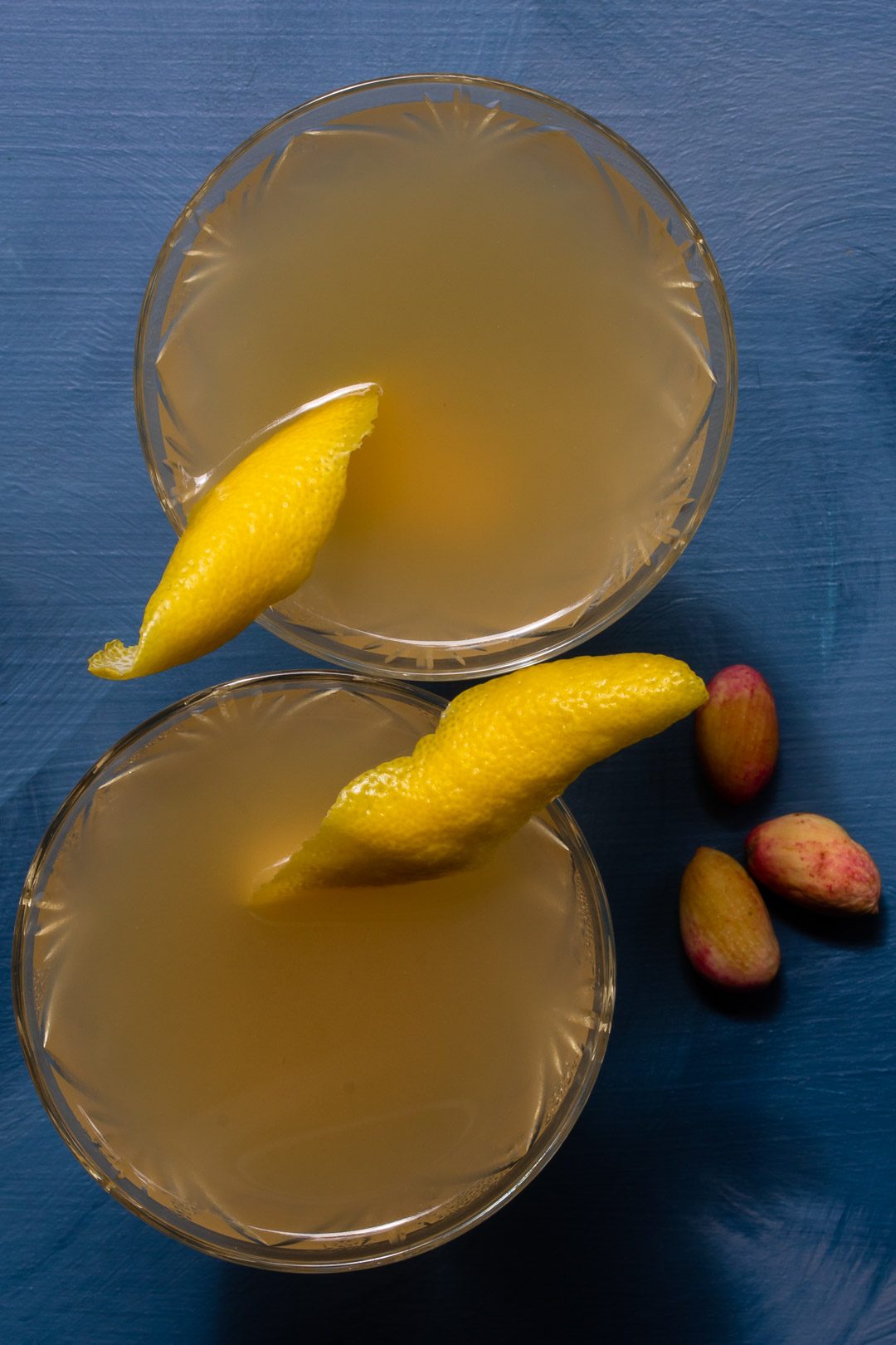 Pistachio rose rhubarb Japanese cocktail two glasses with pistachios from above