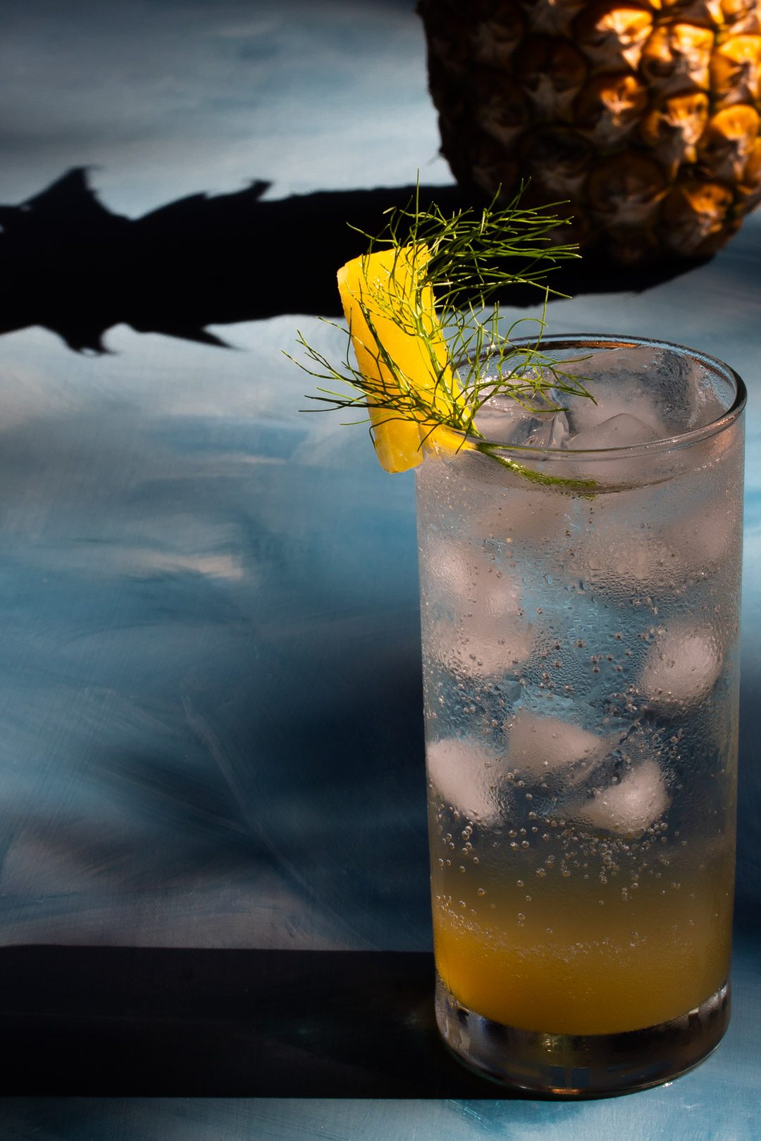 pineapple fennel shrub syrup from 45 degrees with pineapple shadow in the background