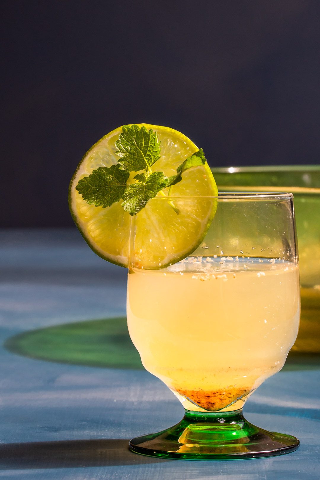 coconut palm arrack punch with green glass bowl in background