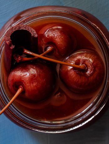 Spiced pickled cherries close up from above