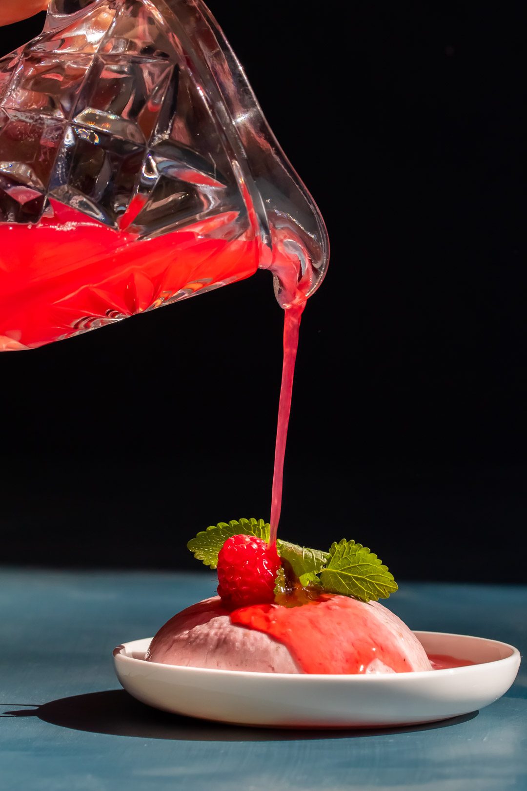 Ice cream made from Raspberry shrub drinking syrup leftovers with jug pouring syrup