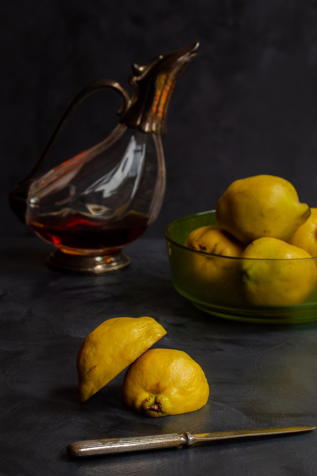 Making Vintage Quince Cordial cut quince in foreground