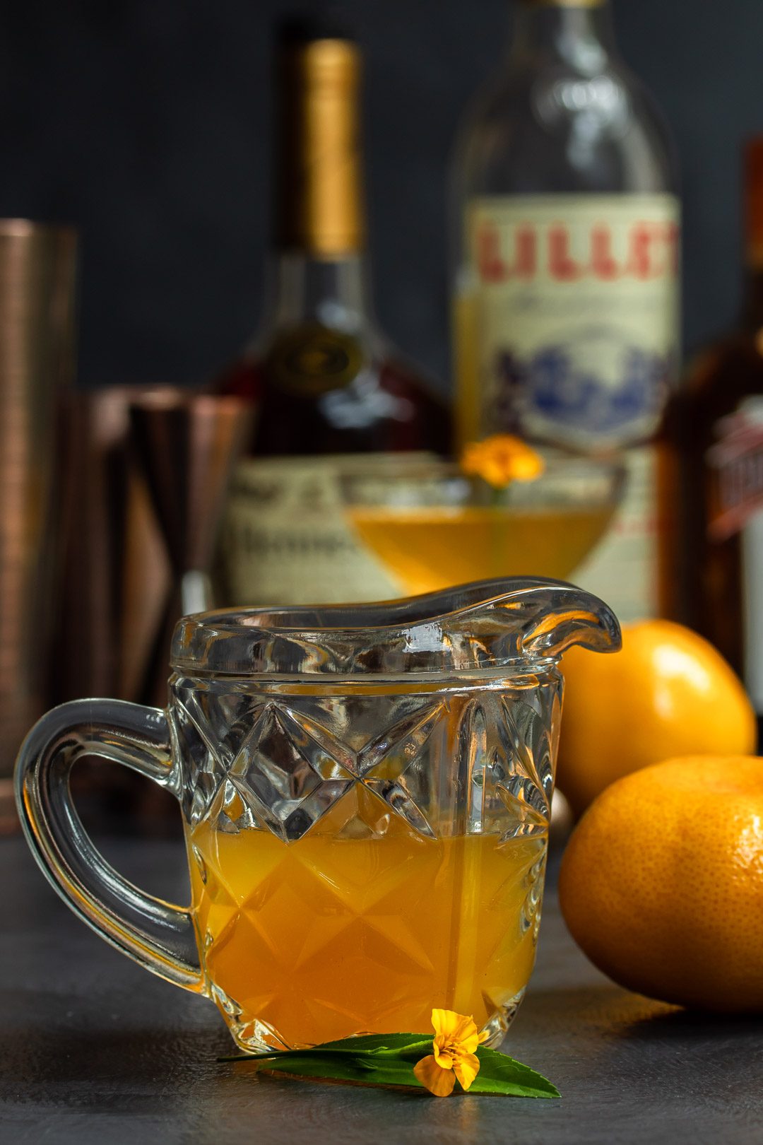 Mandarin tarragon shrub syrup drinking vinegar with cocktail gear in background