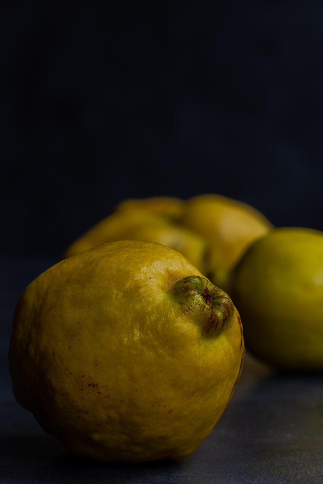 Making Vintage Quince Cordial with quinces in a row front one to left of centre