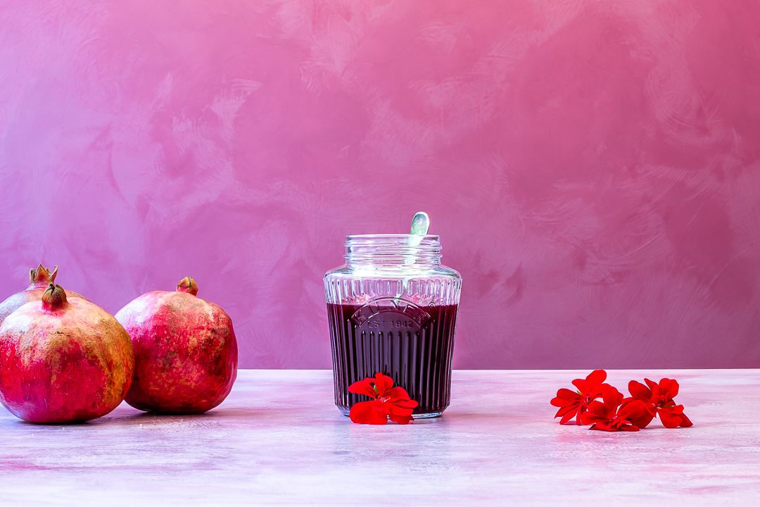 grenadine syrup with pomegranates and geranium flowers