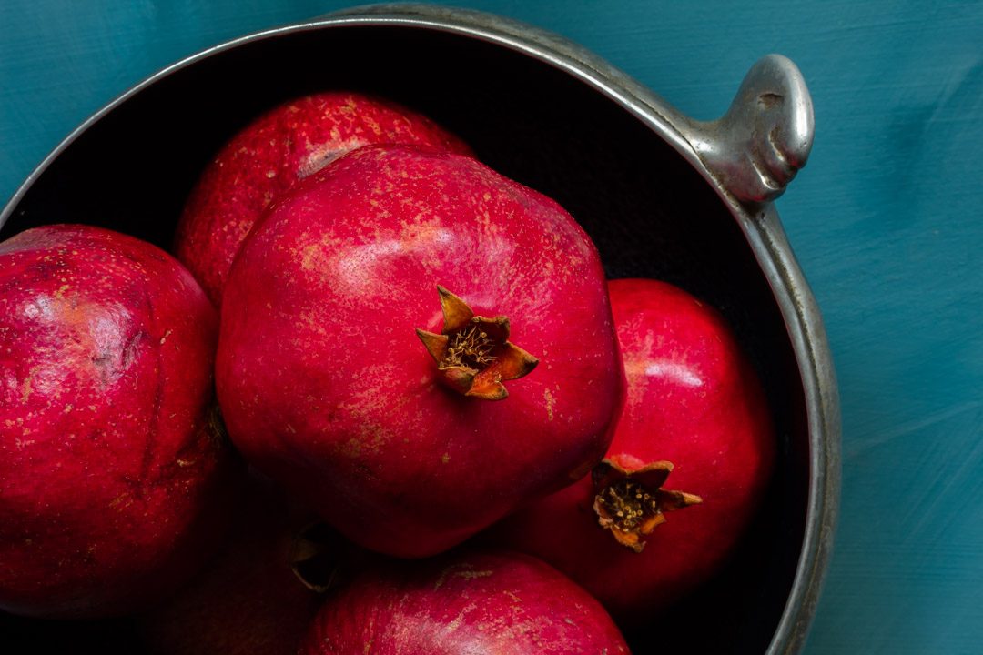 metal bowl of pomegranates used to make grenadine from above