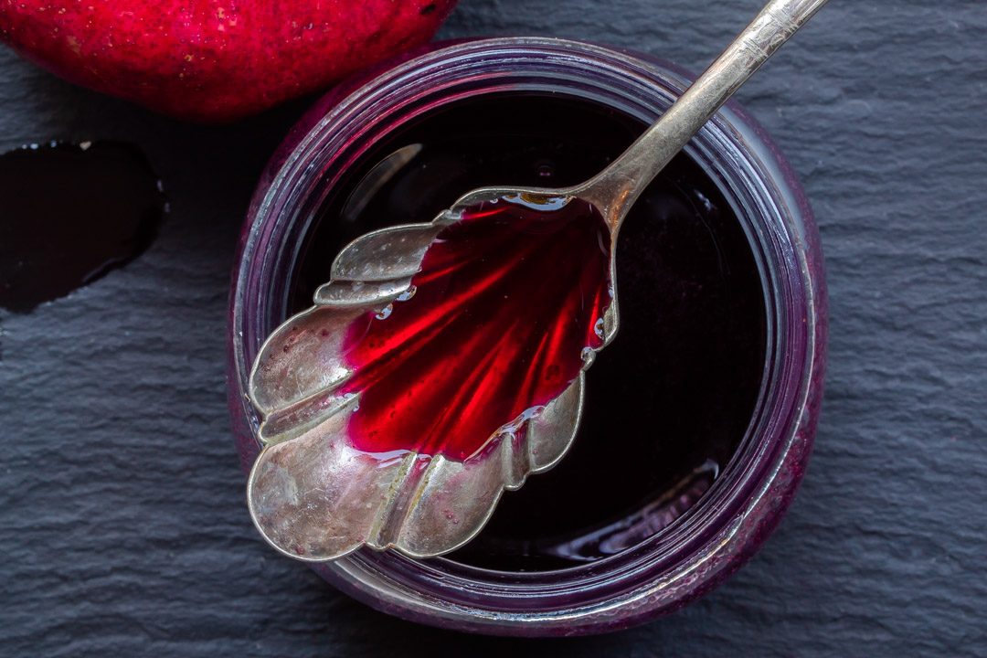 pomegranate molasses with vintage spoon used to make grenadine