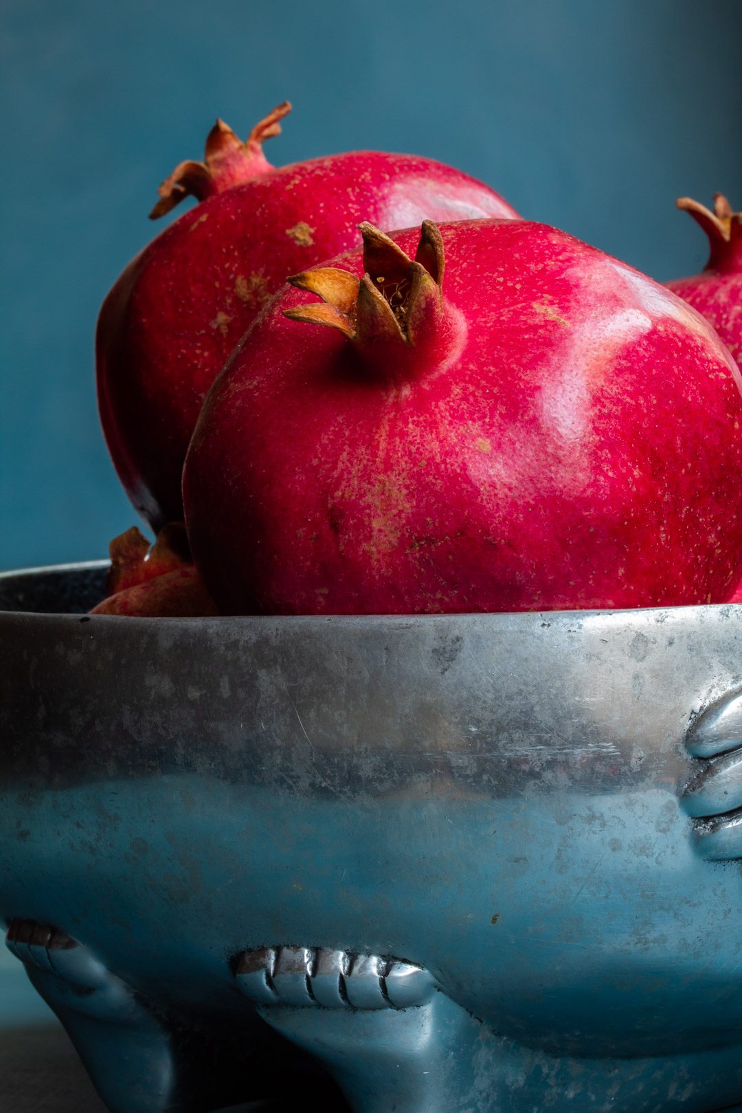 pomegranates in metal bowl close up used to make grenadine