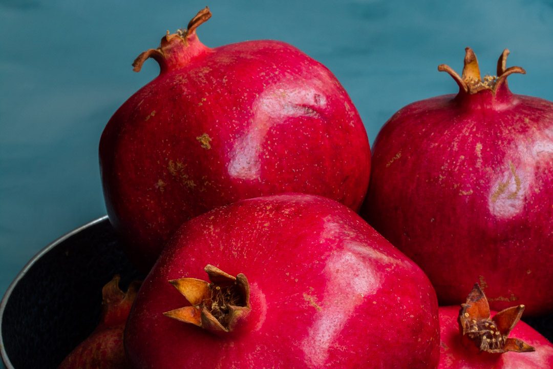 pomegranates in metal bowl close up used to make grenadine