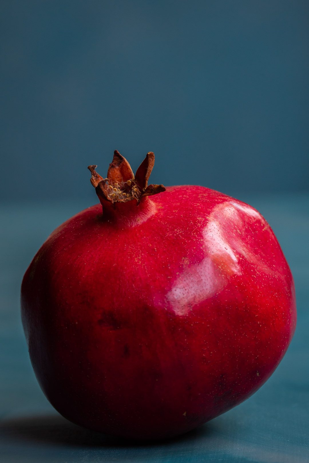 pomegranate solo on blue background used to make grenadine