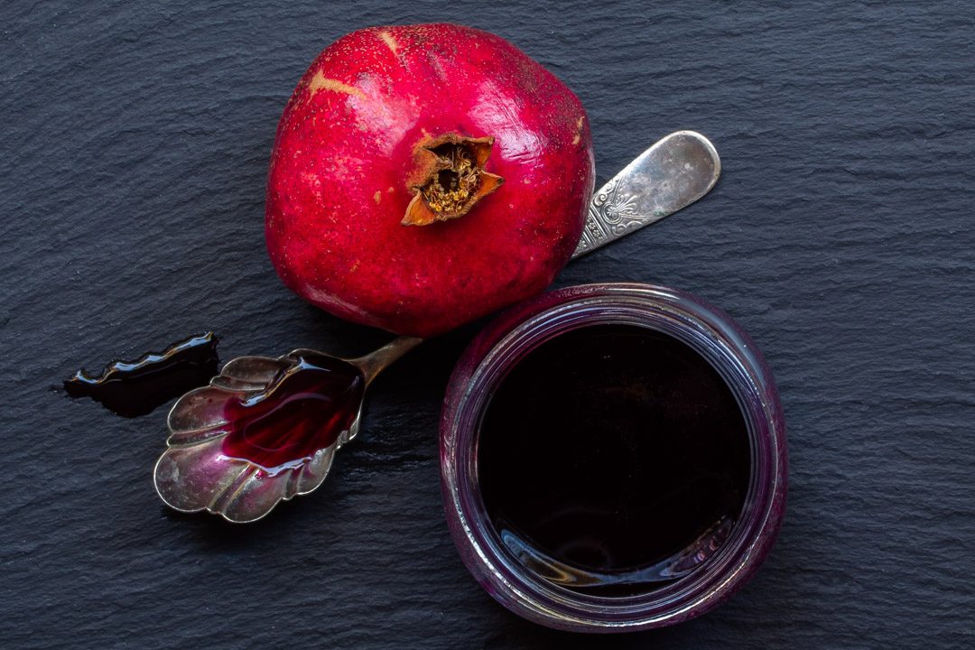 grenadine or pomegranate syrup from above with vintage spoon and pomegranate