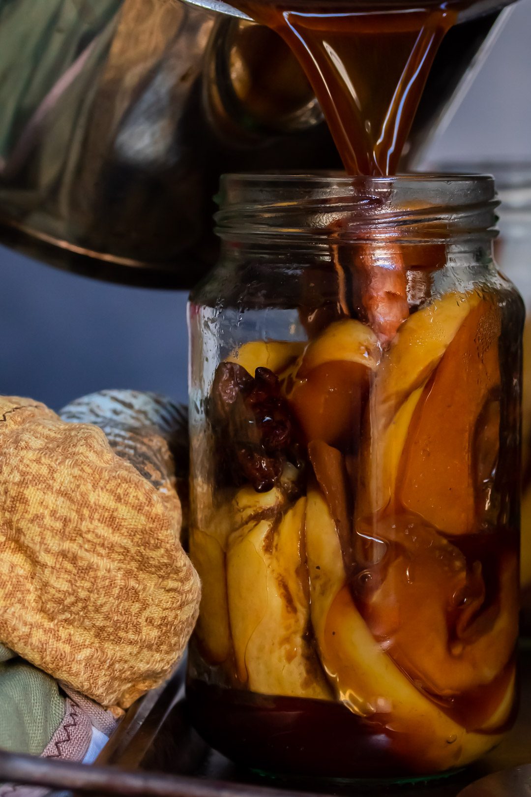 pouring hot brine to make spiced pickled quinces