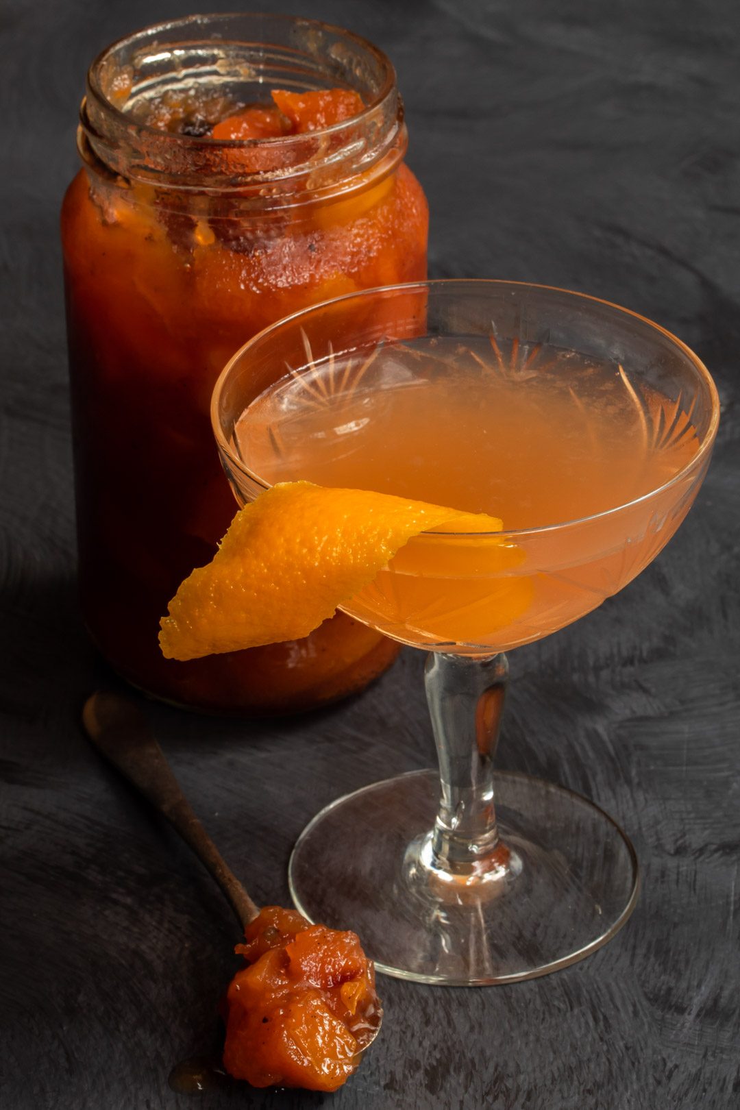 quince apple jam gin sour cocktail from 45 degrees with spoon of jam and jam jar