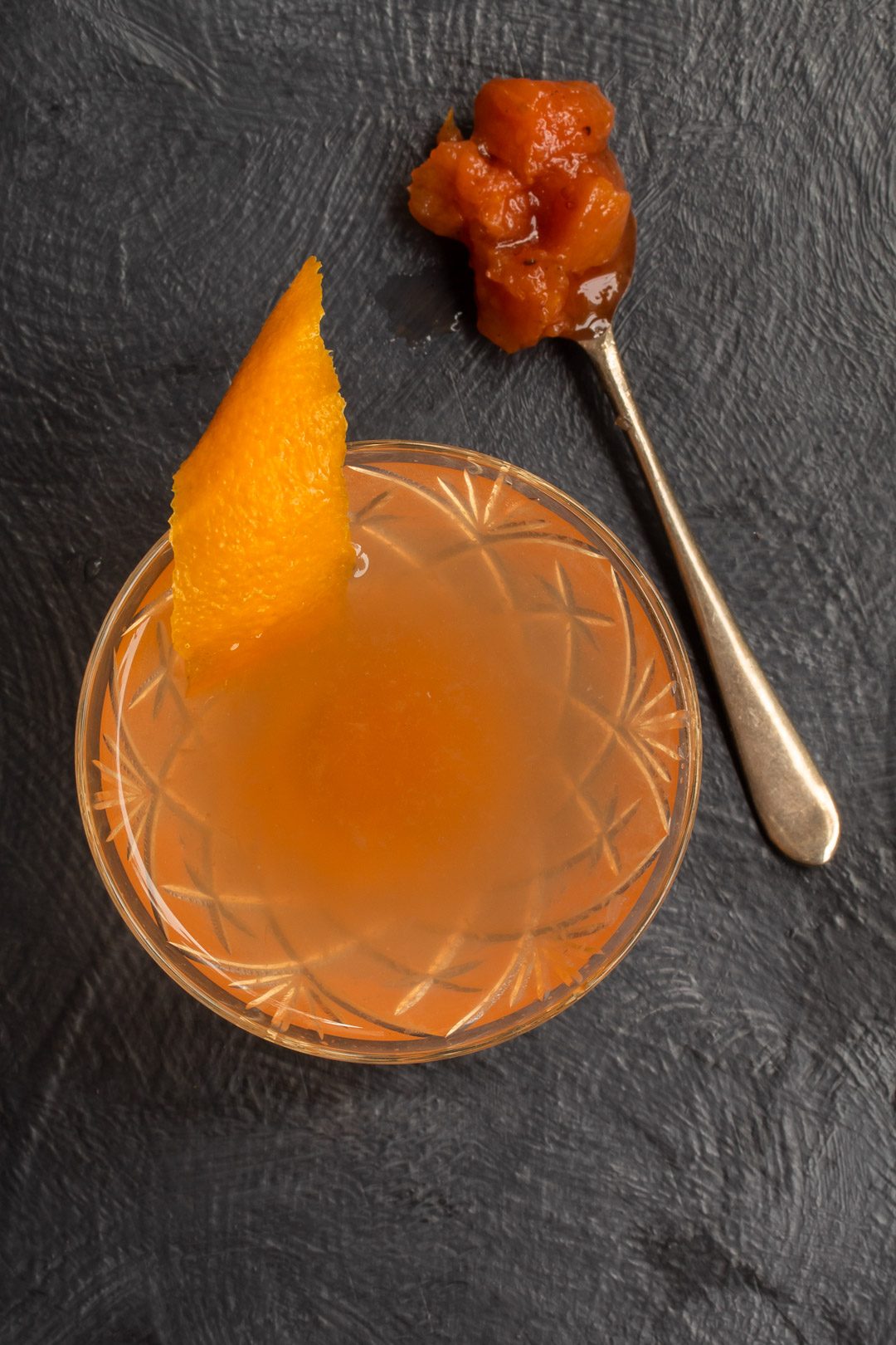 quince apple jam gin sour cocktail from above with spoon of jam