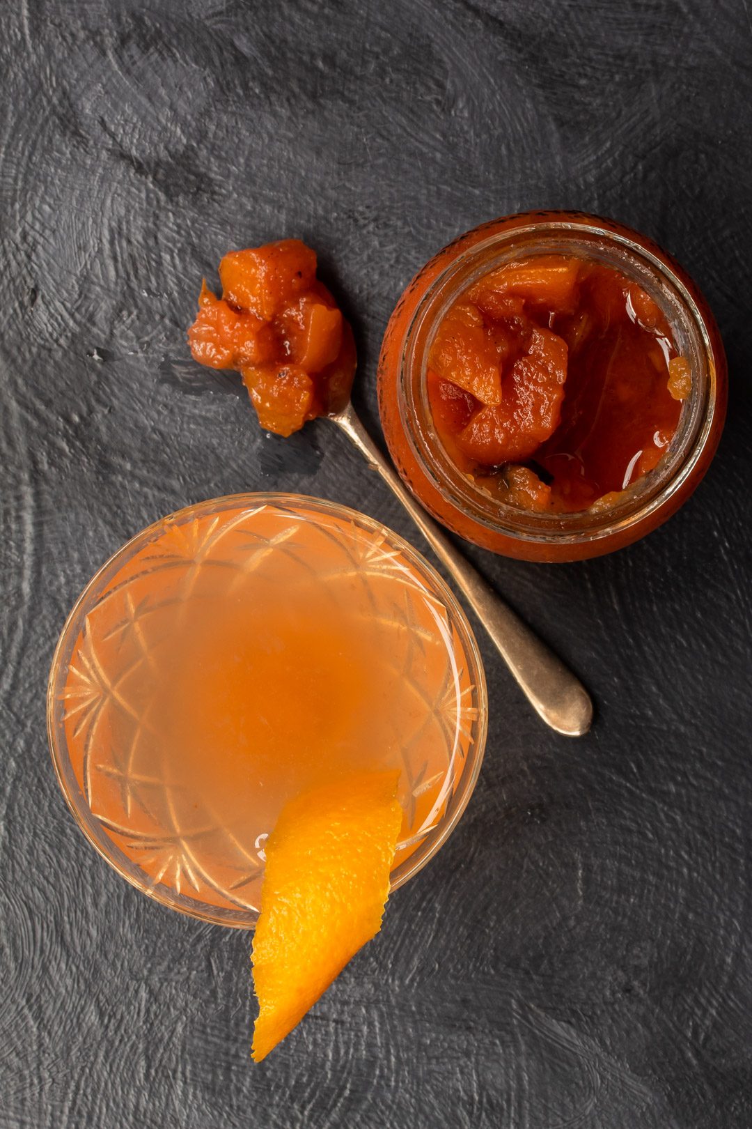 quince apple jam gin sour cocktail from above with spoon of jam and jam jar