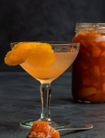 quince apple jam gin sour cocktail with jam jar in background and spoon of jam in foreground