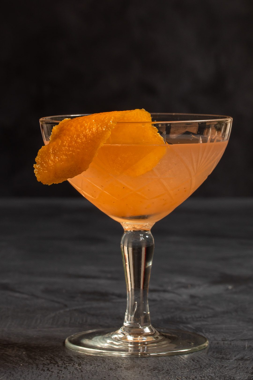 quince apple jam gin sour cocktail solo on grey textured background