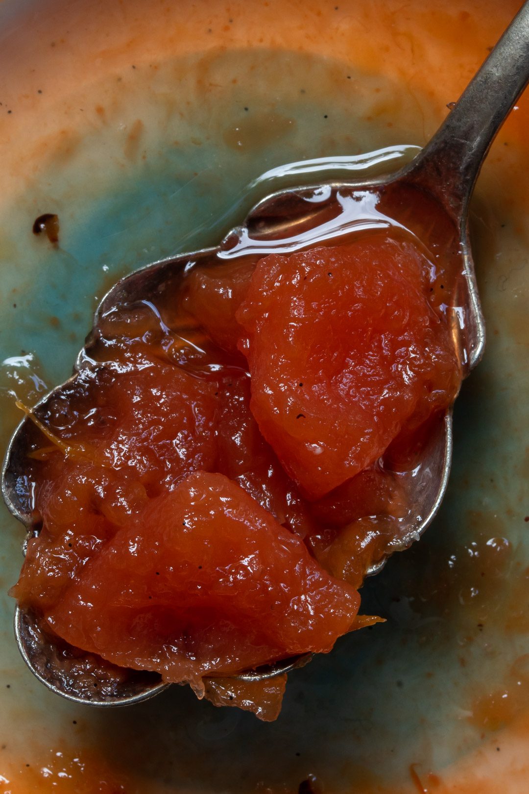 Rustic quince apple jam on vintage spoon close up