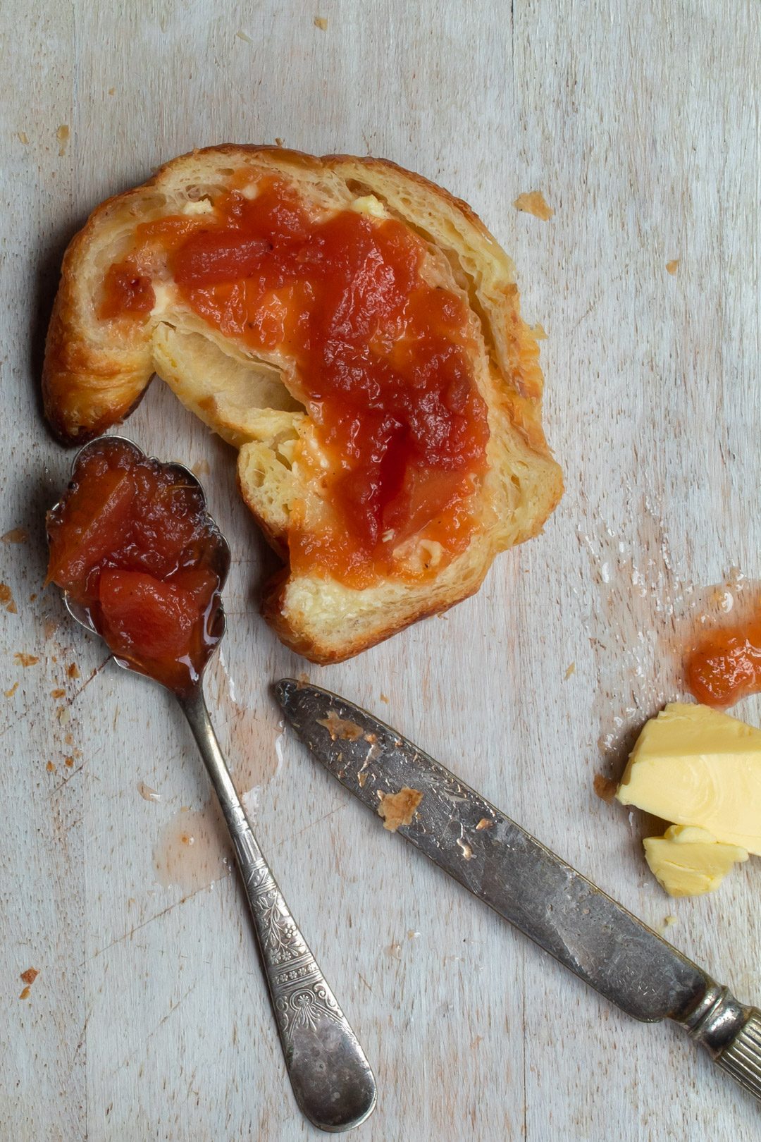 rustic quince apple jam with half a split croissant