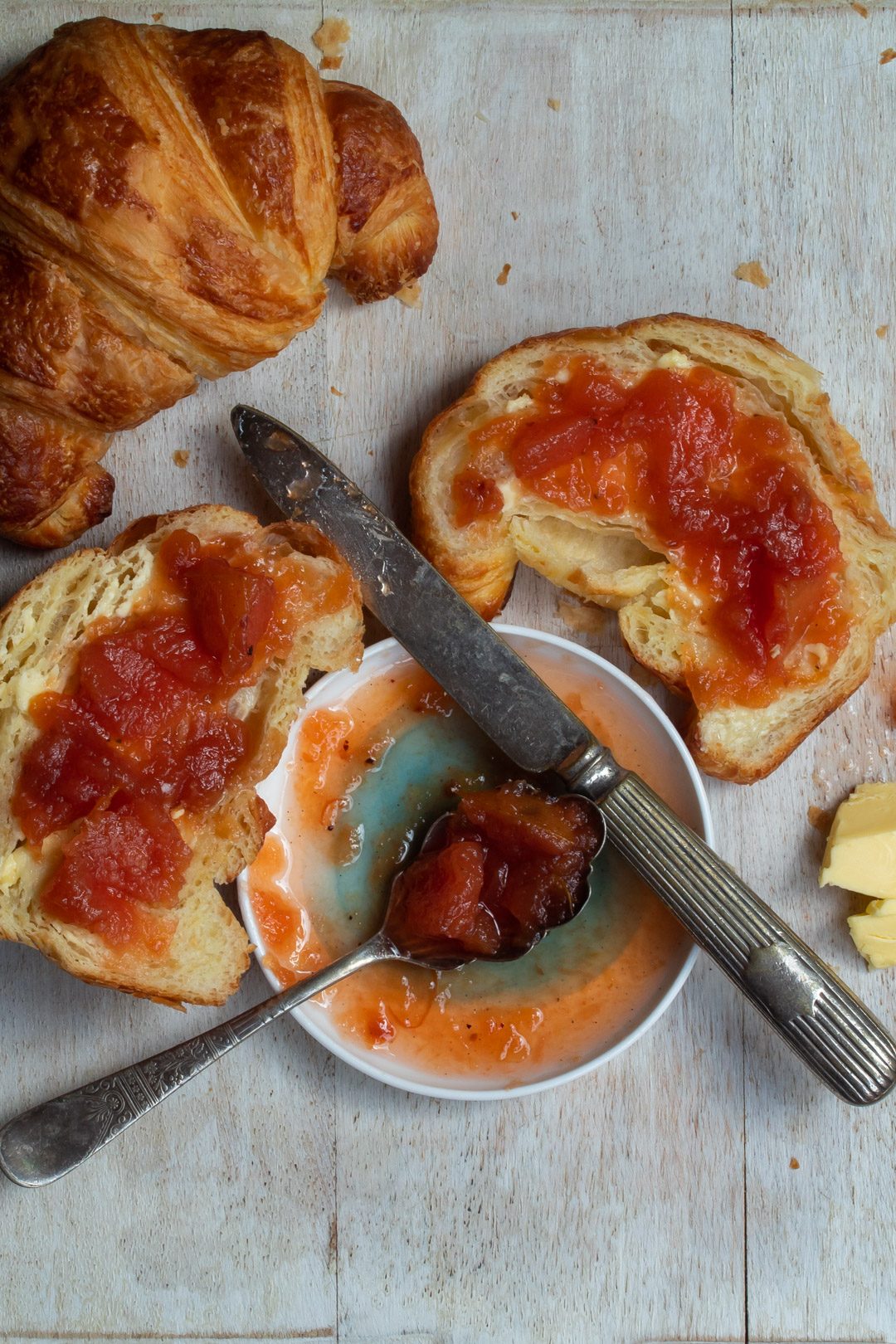 rustic quince apple jam with split croissant and whole croissant