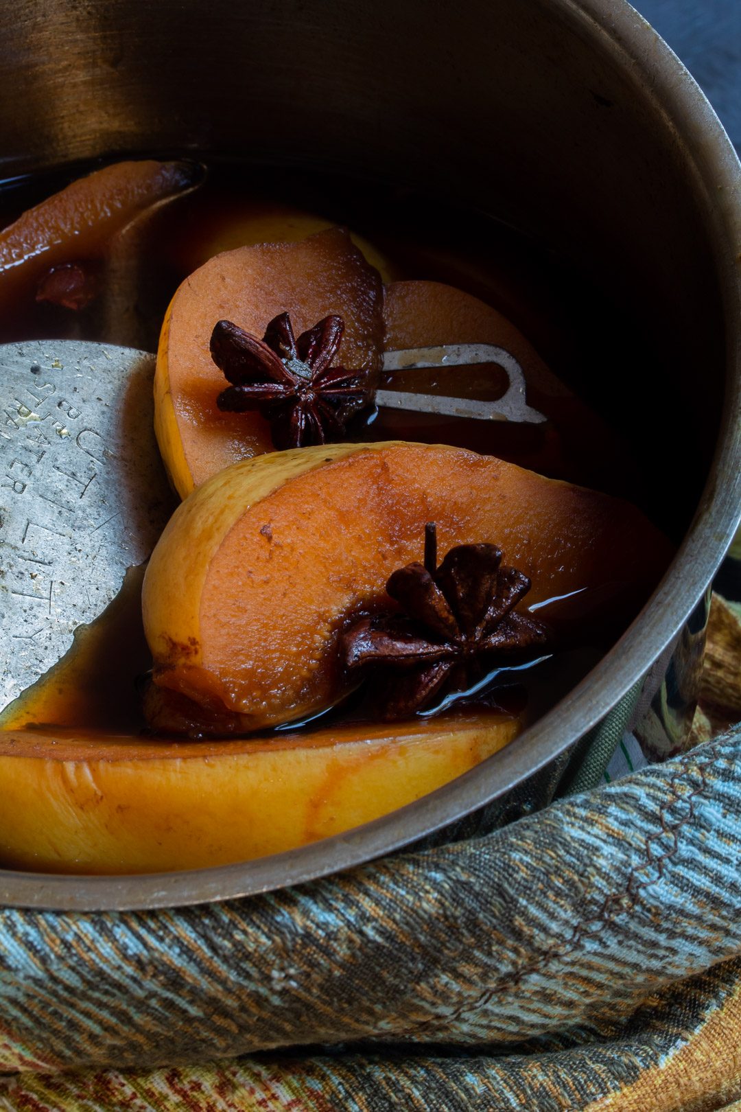 Spiced pickled quinces in saucepan