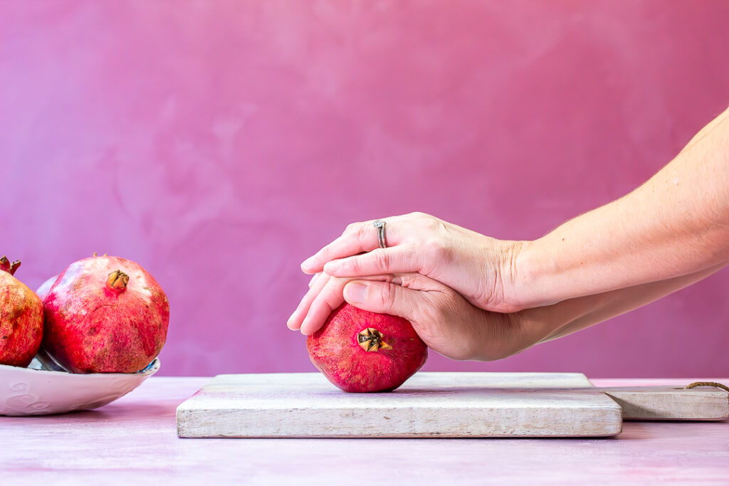 begin rolling a pomegranate for grenadine horizontal