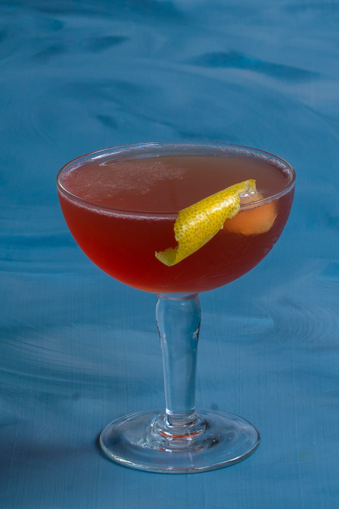 Harry’s pick me up cocktail isolated on blue background