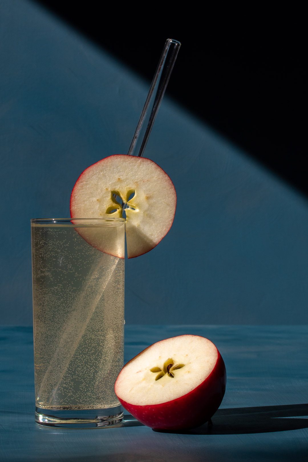 apple shrub gin fizz cocktail with shadows and lines close up